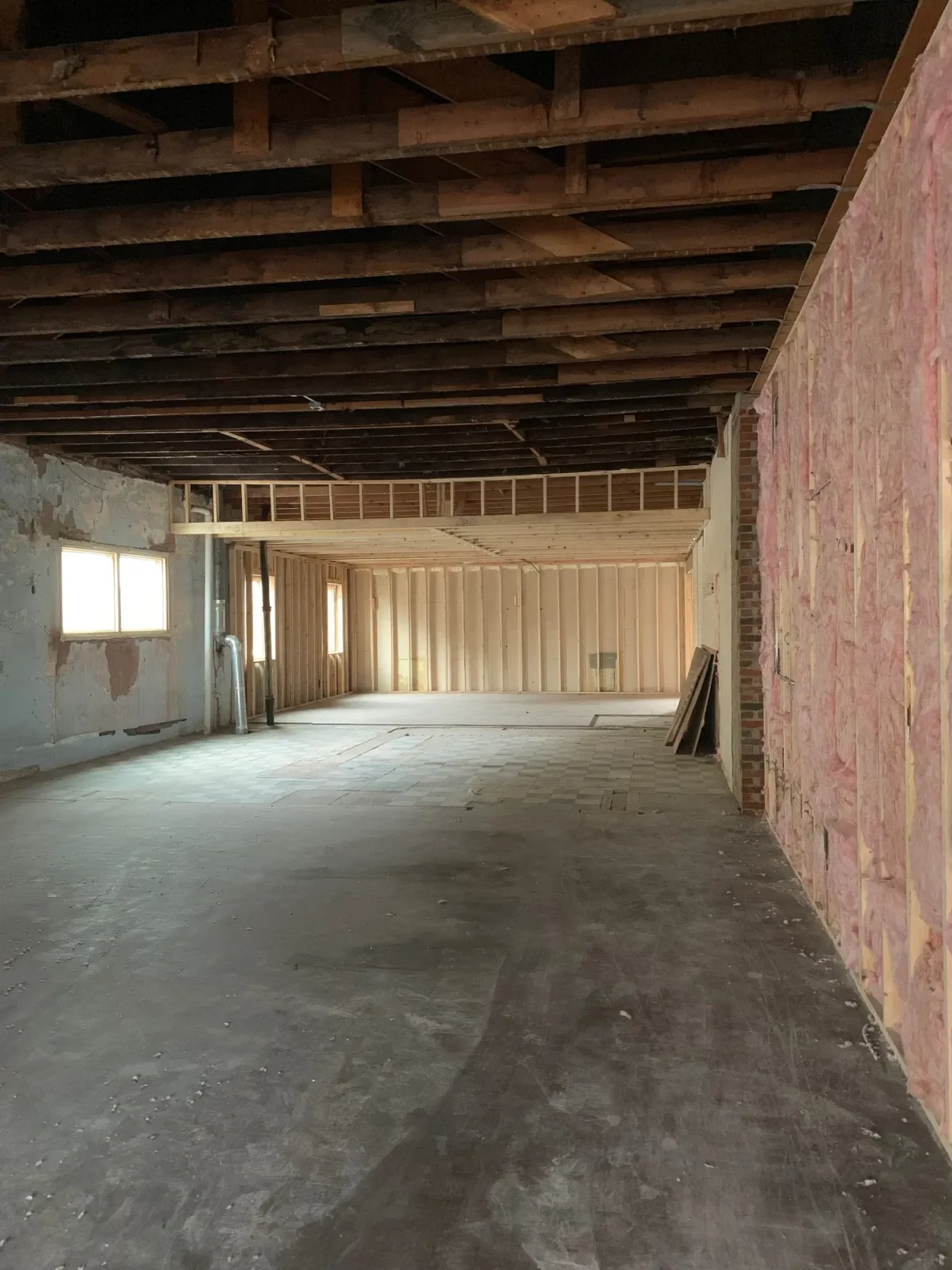 The interior stripped back to raw concrete and exposed brick during the 2018 restoration