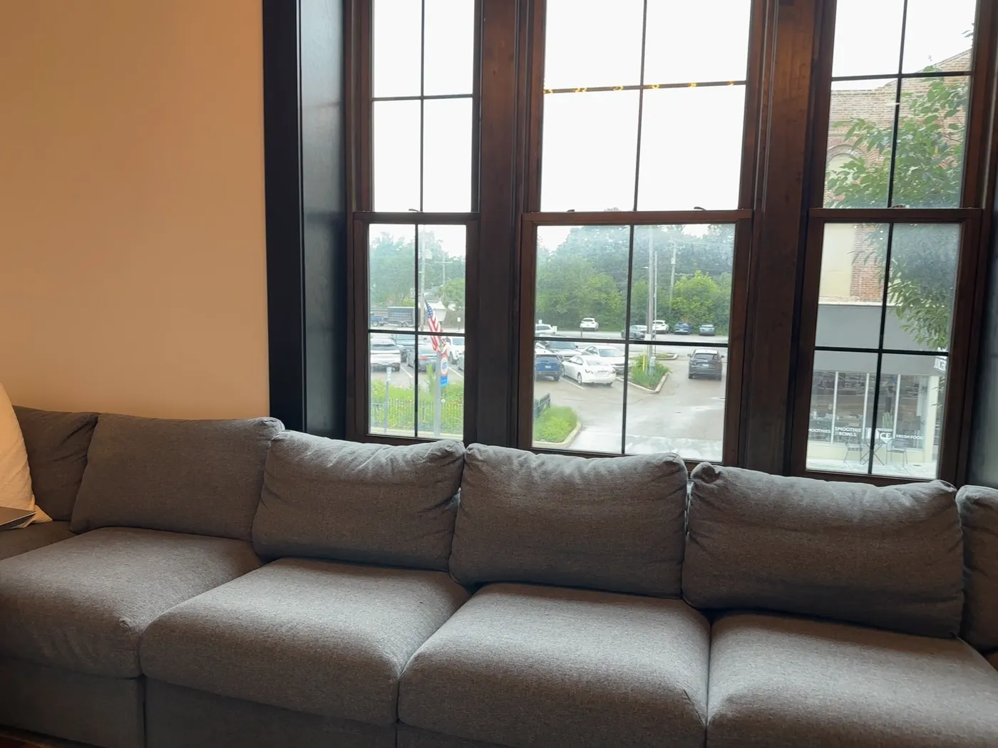 The lounge at The Lodge with a sectional and tall windows